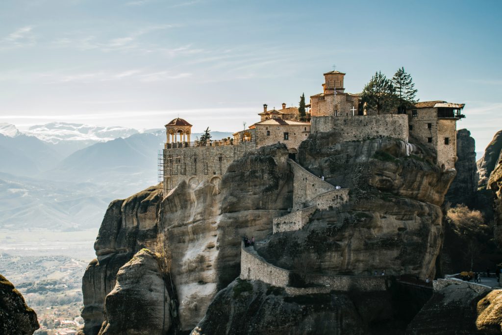 a stone building on a cliff
