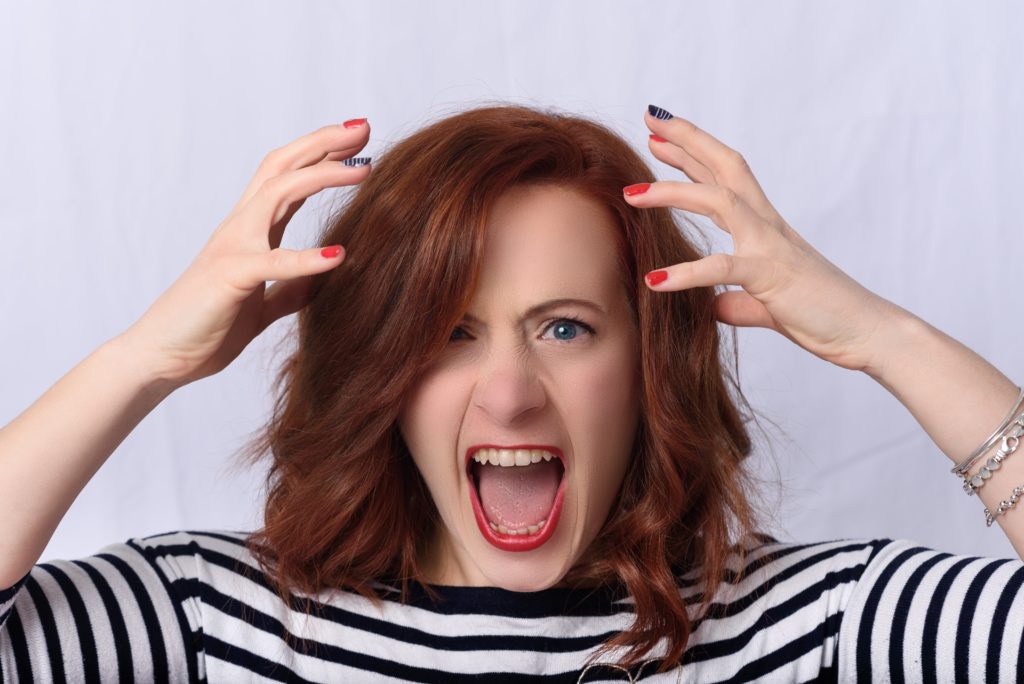 a woman with red hair screaming