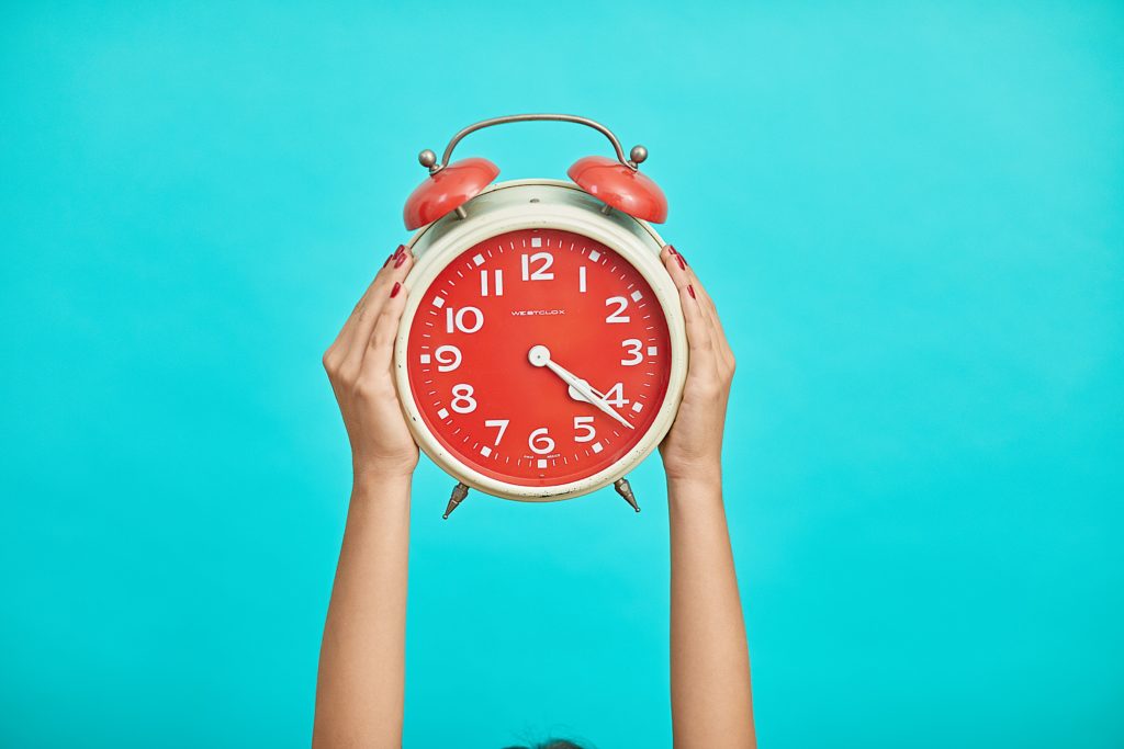a person holding a clock