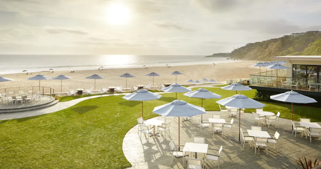 a beach with umbrellas and chairs