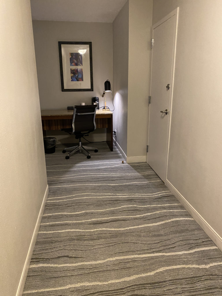 a hallway with a desk and chair