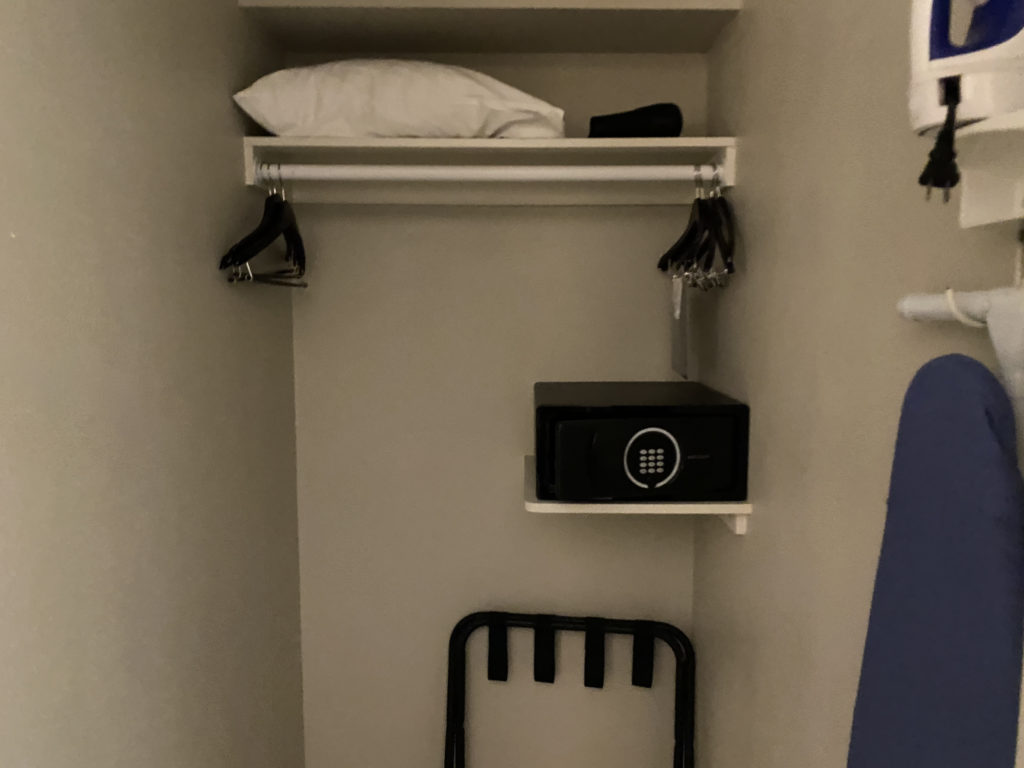 a small closet with a small black box and swingers