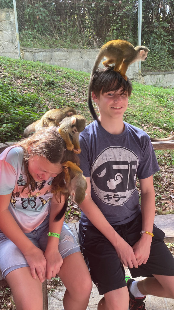 a boy and girl with monkeys on their head
