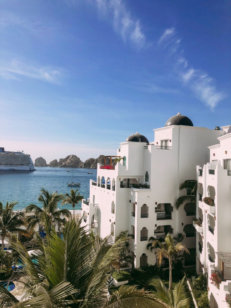 a white building next to a body of water