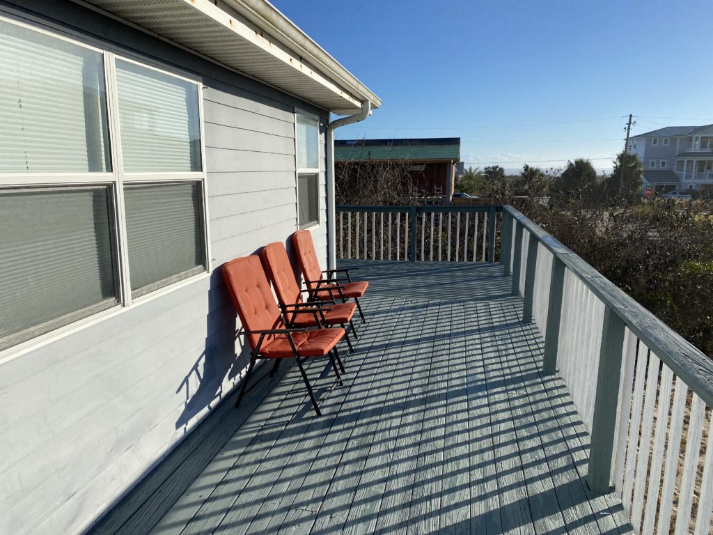 a row of chairs on a deck