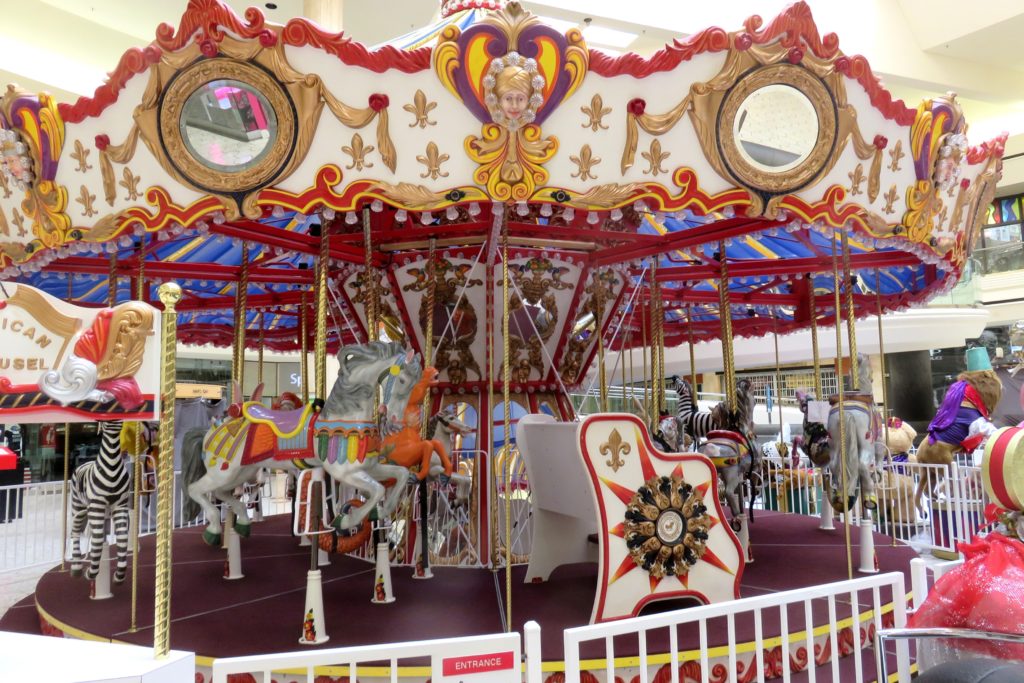 a carousel with horses and zebras
