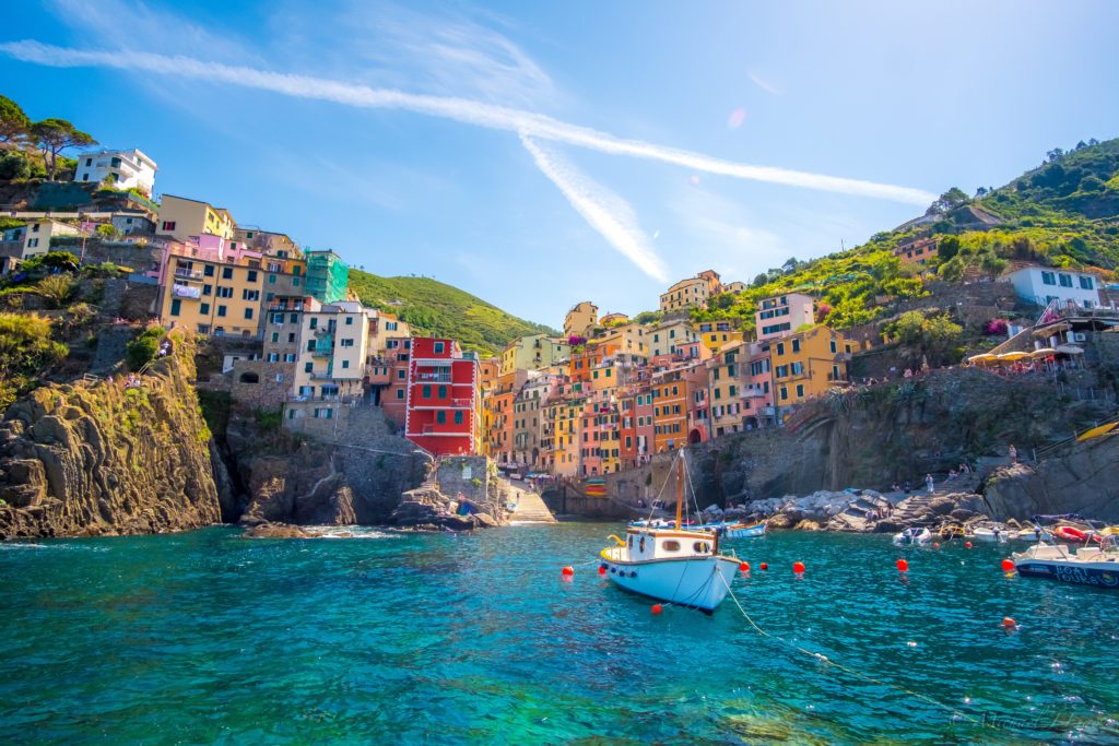 a boat in the water with Cinque Terre in the background