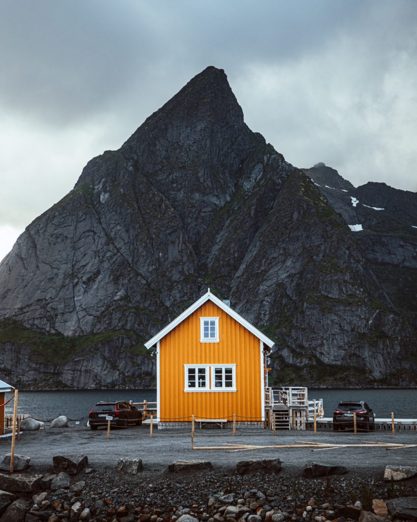 a yellow house next to a body of water