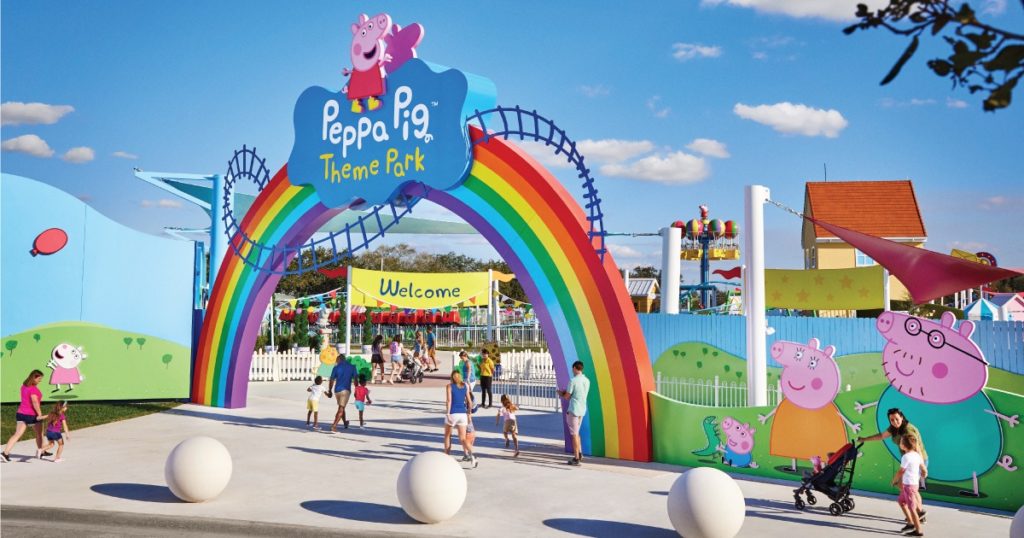 a rainbow arch with people walking around