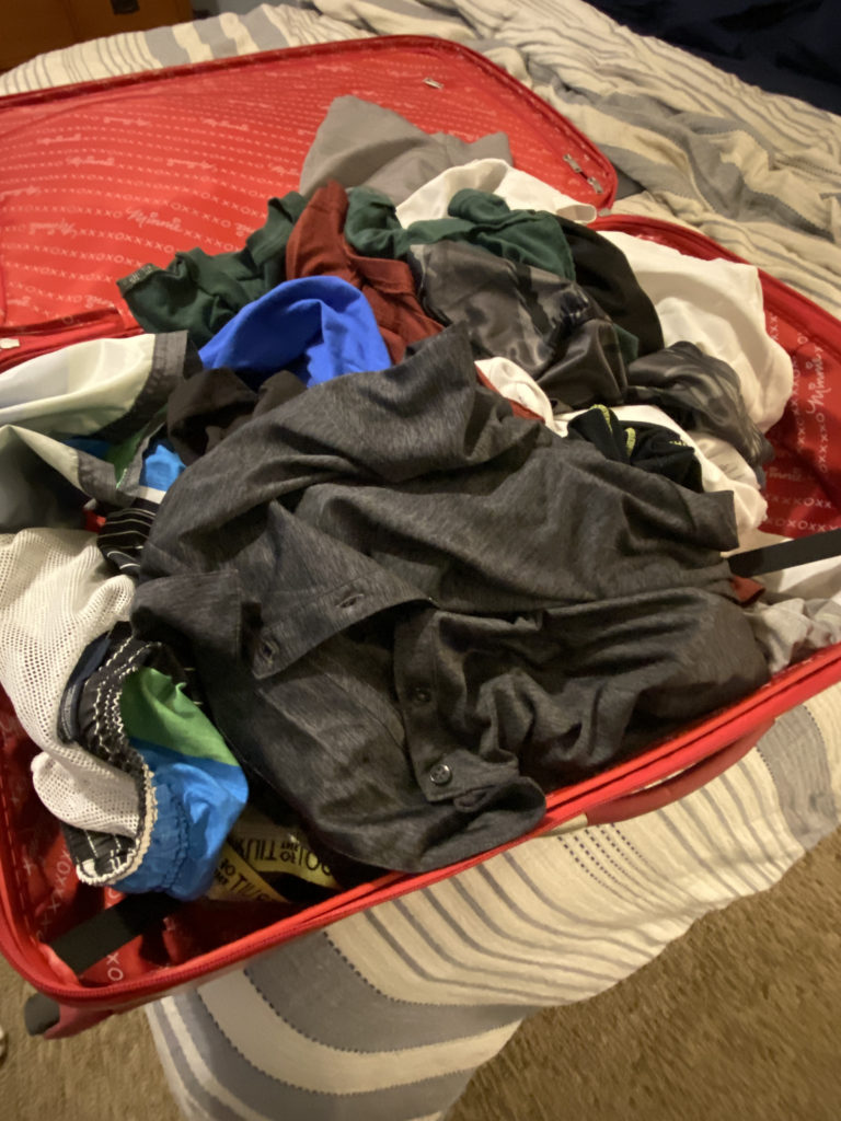 a red suitcase full of clothes