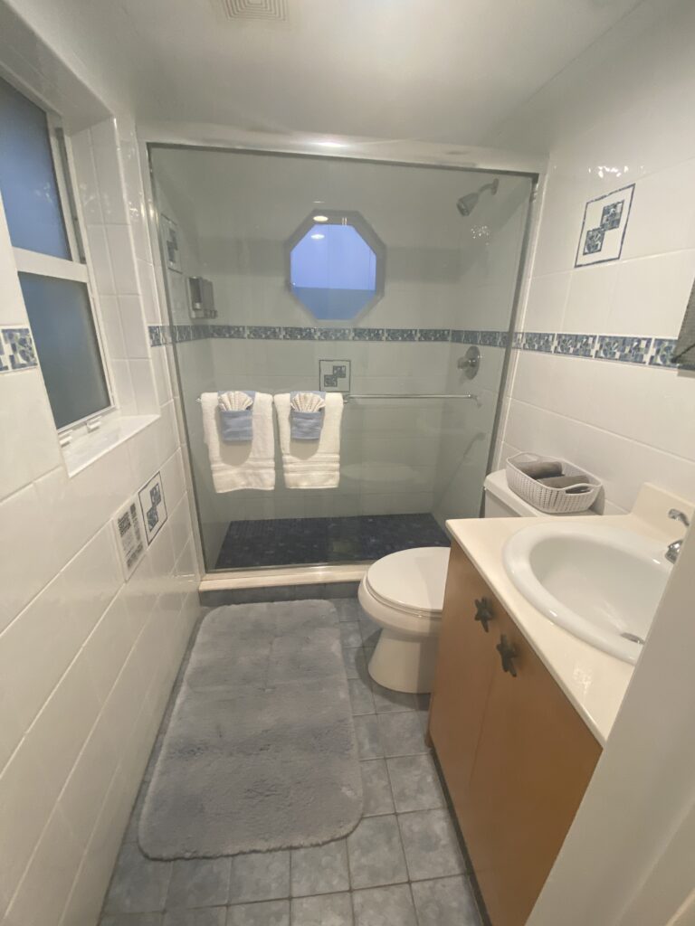 a bathroom with a glass shower door
