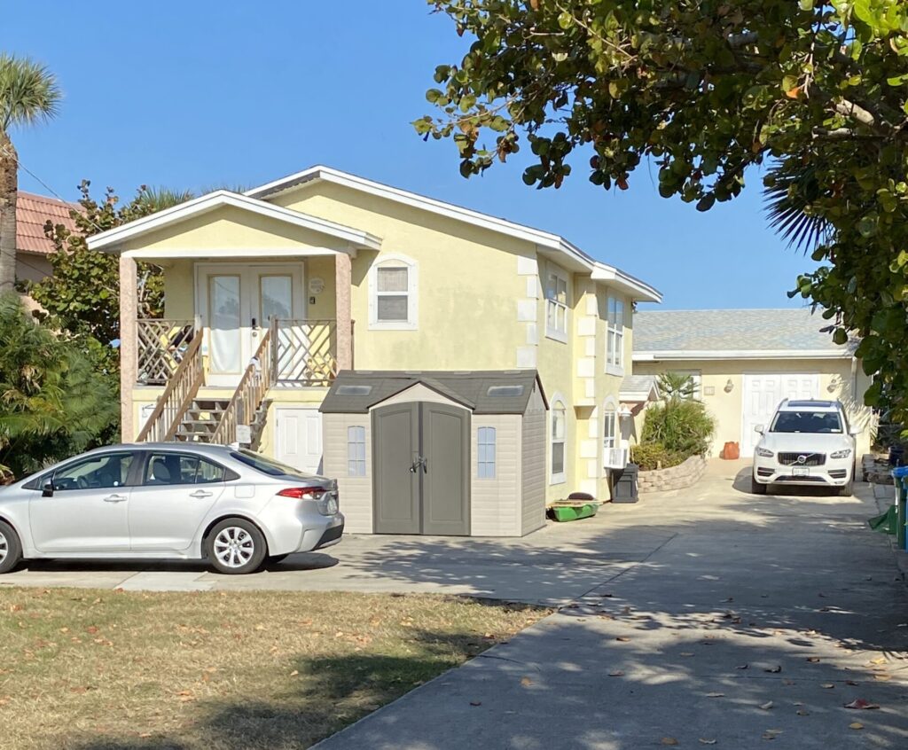 a house with a garage and a car parked in front of it