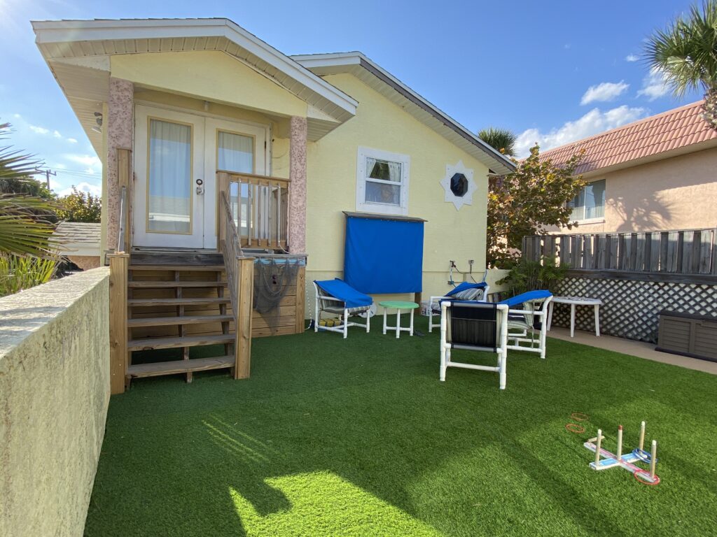 a house with a lawn and chairs