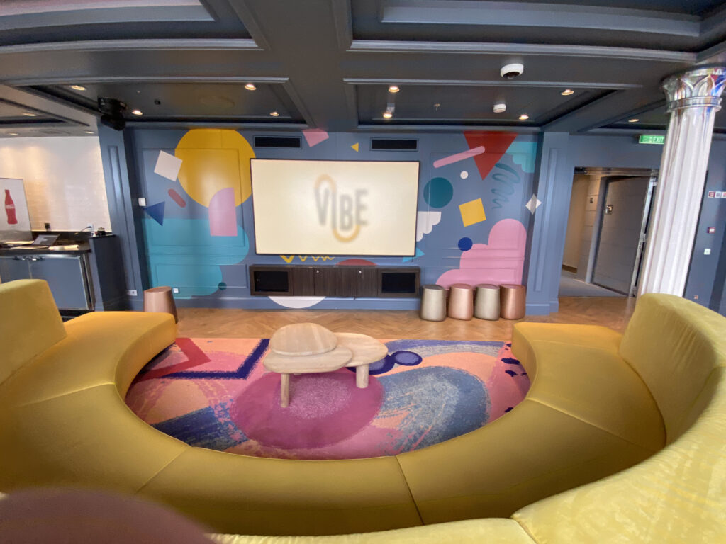 a room with a large screen and a couch