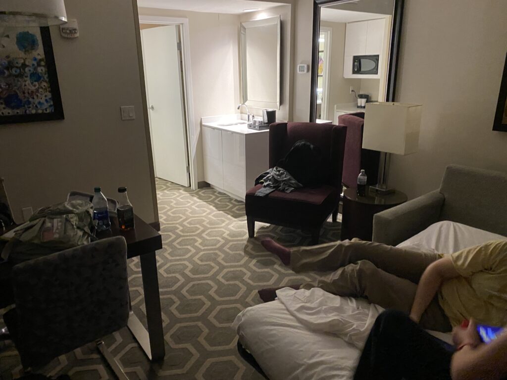 a person lying on a bed in a hotel room