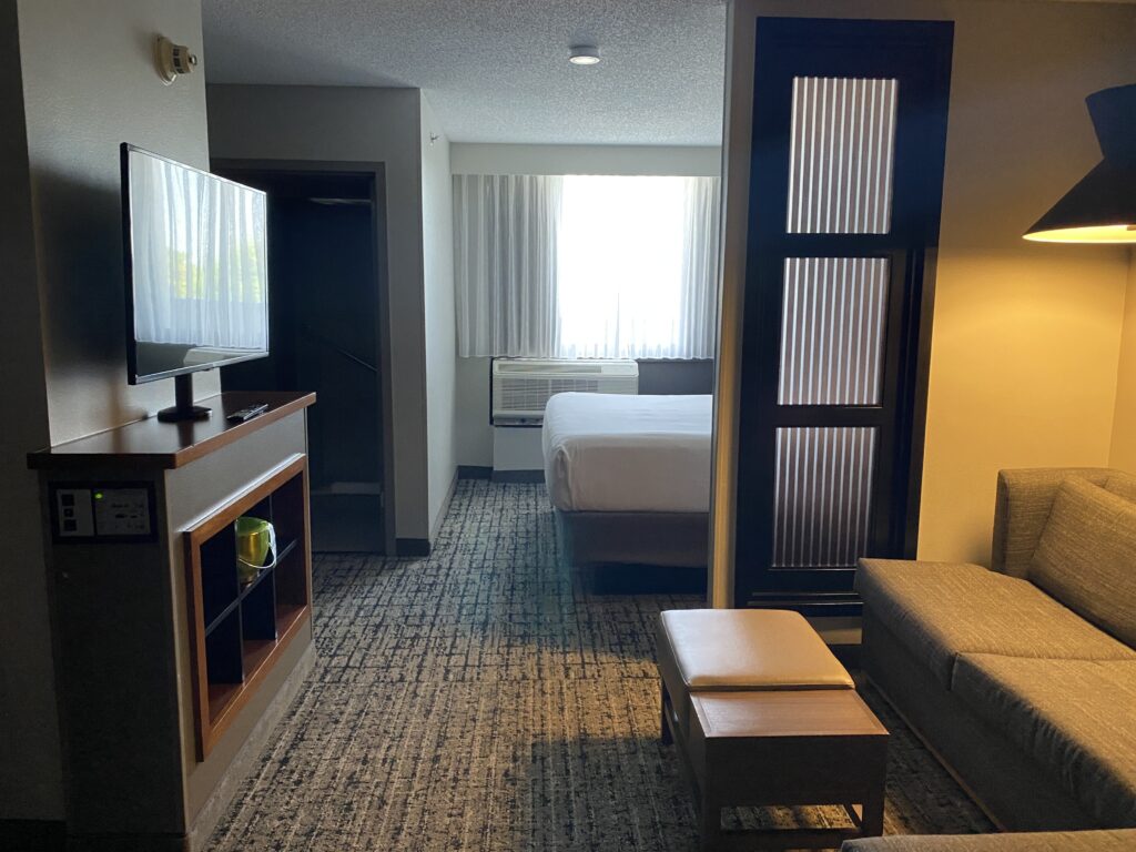 a room with a bed and a television