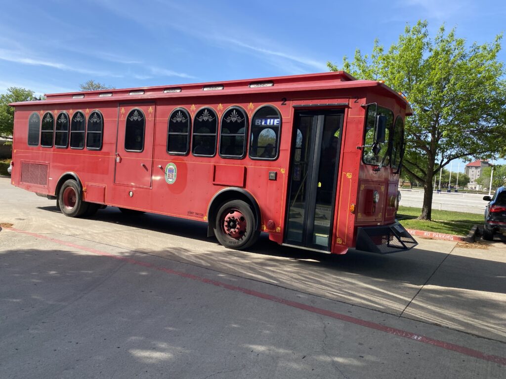 a red bus parked on the side of a road