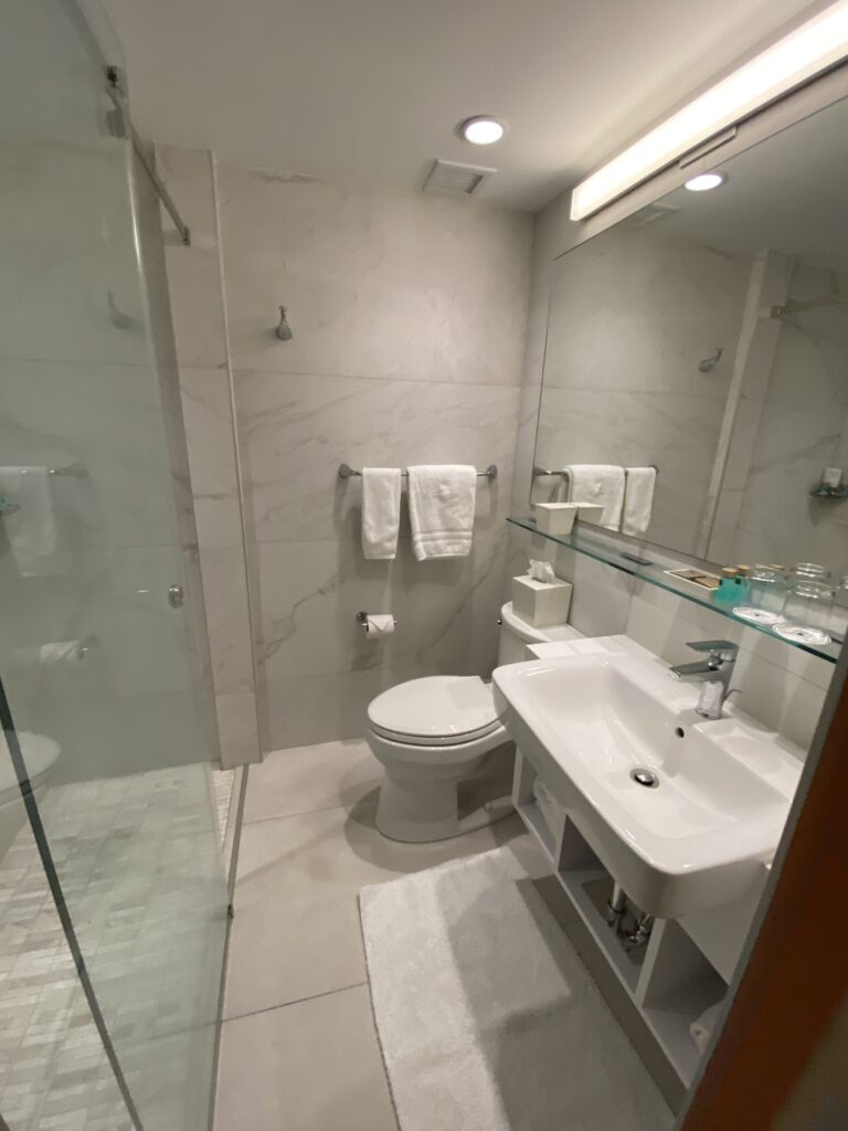 a bathroom with a glass shower door and toilet