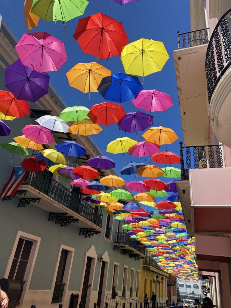 a group of umbrellas over a street