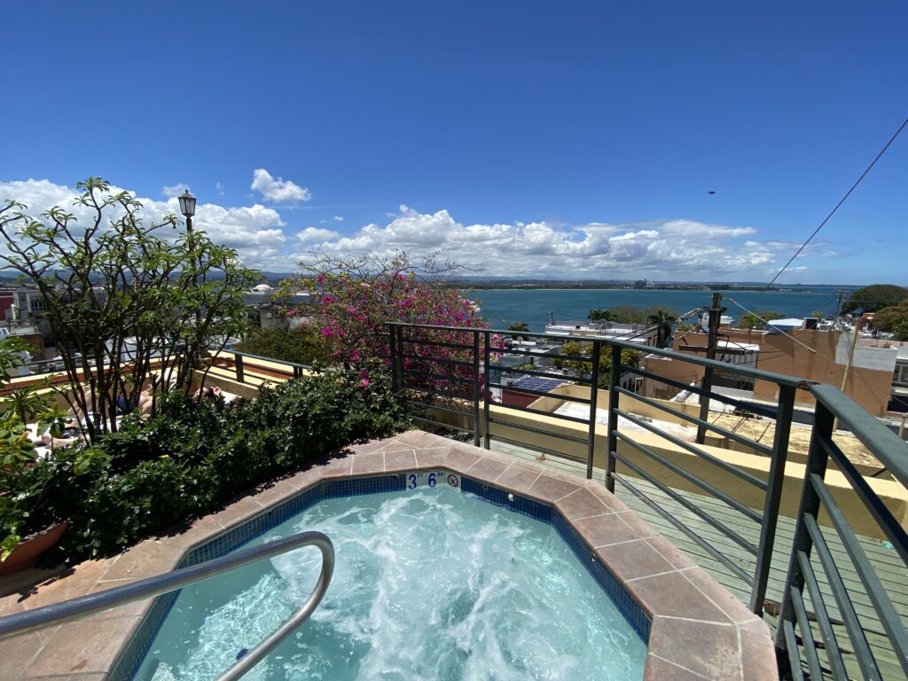 a hot tub on a rooftop overlooking a body of water