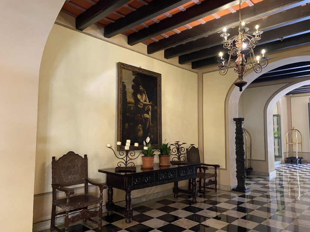 a room with a checkered floor and a table and chairs