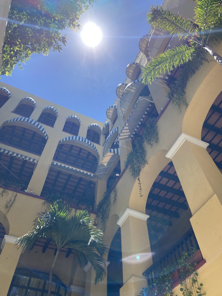 a building with many balconies and palm trees