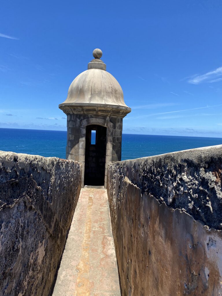 a stone tower with a dome on top and a blue sky