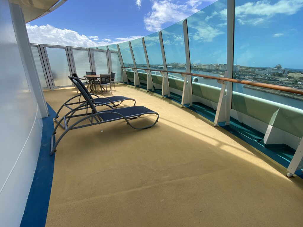 chairs on a deck with a table and chairs