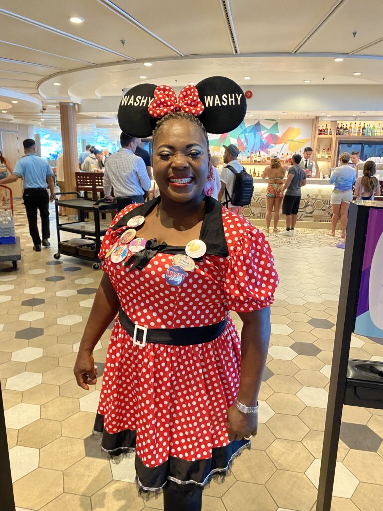 a woman in a red dress with white polka dots and ears