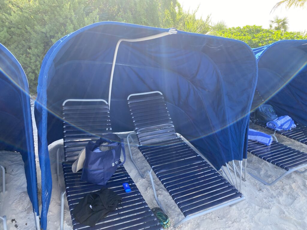 a group of chairs and a tent on a beach