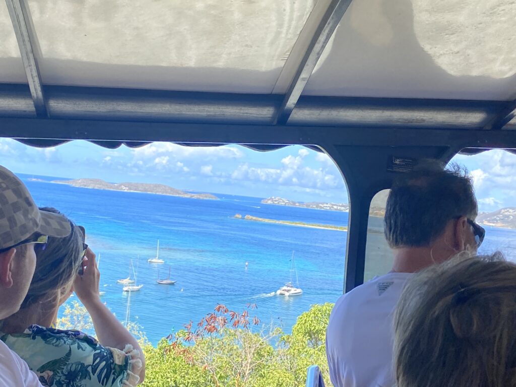 a group of people looking out a window at a body of water