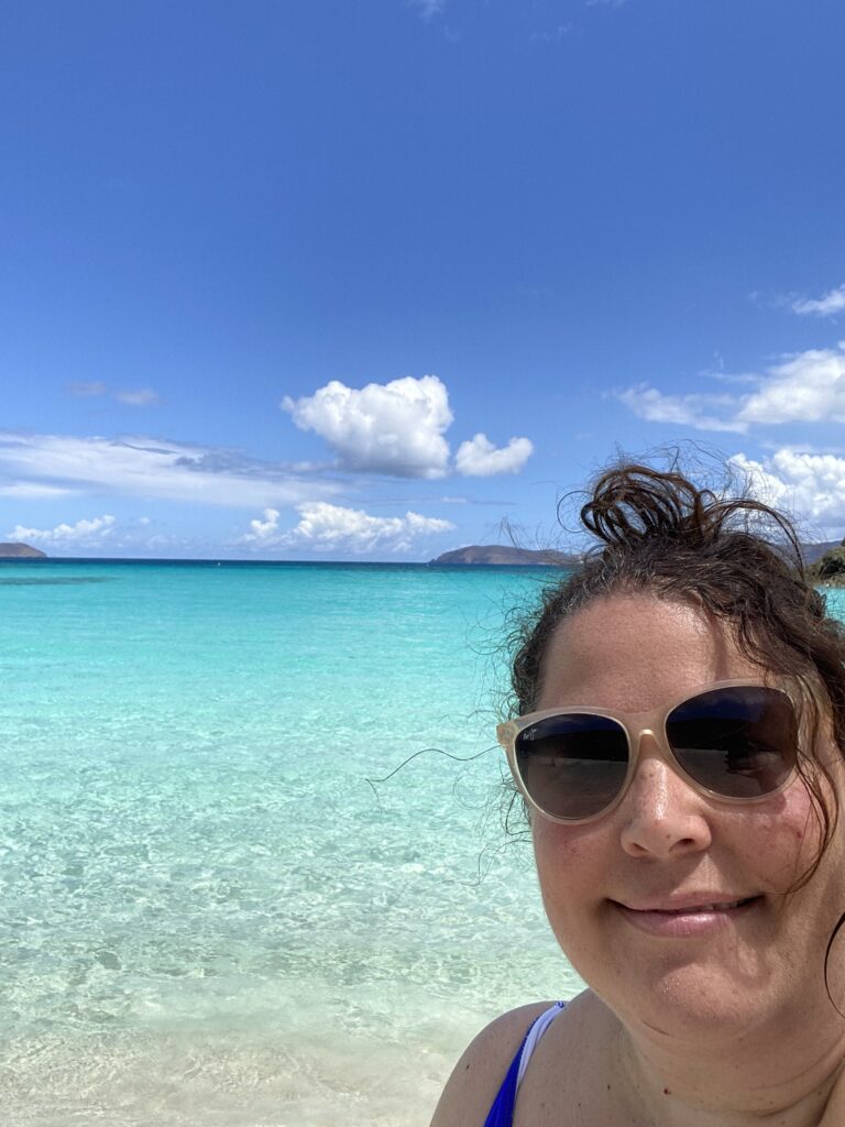 a woman taking a selfie in front of a body of water
