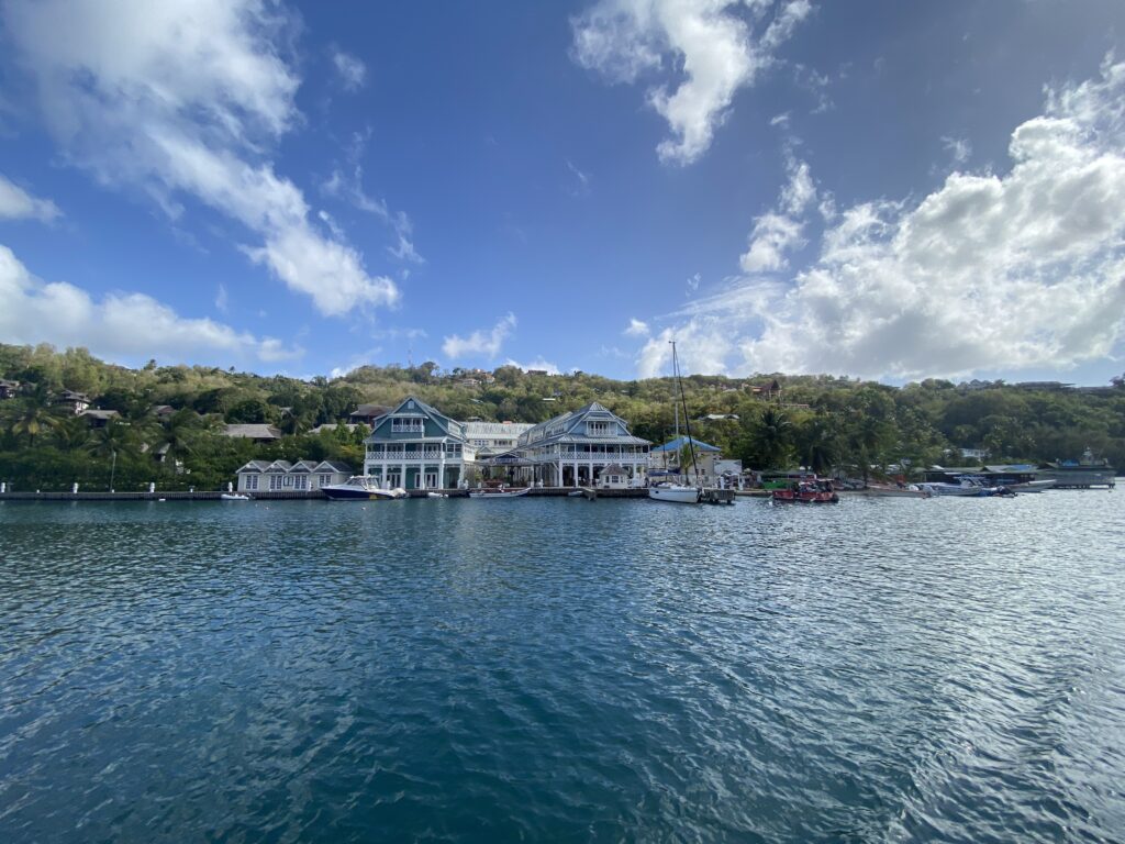a body of water with houses and trees in the background