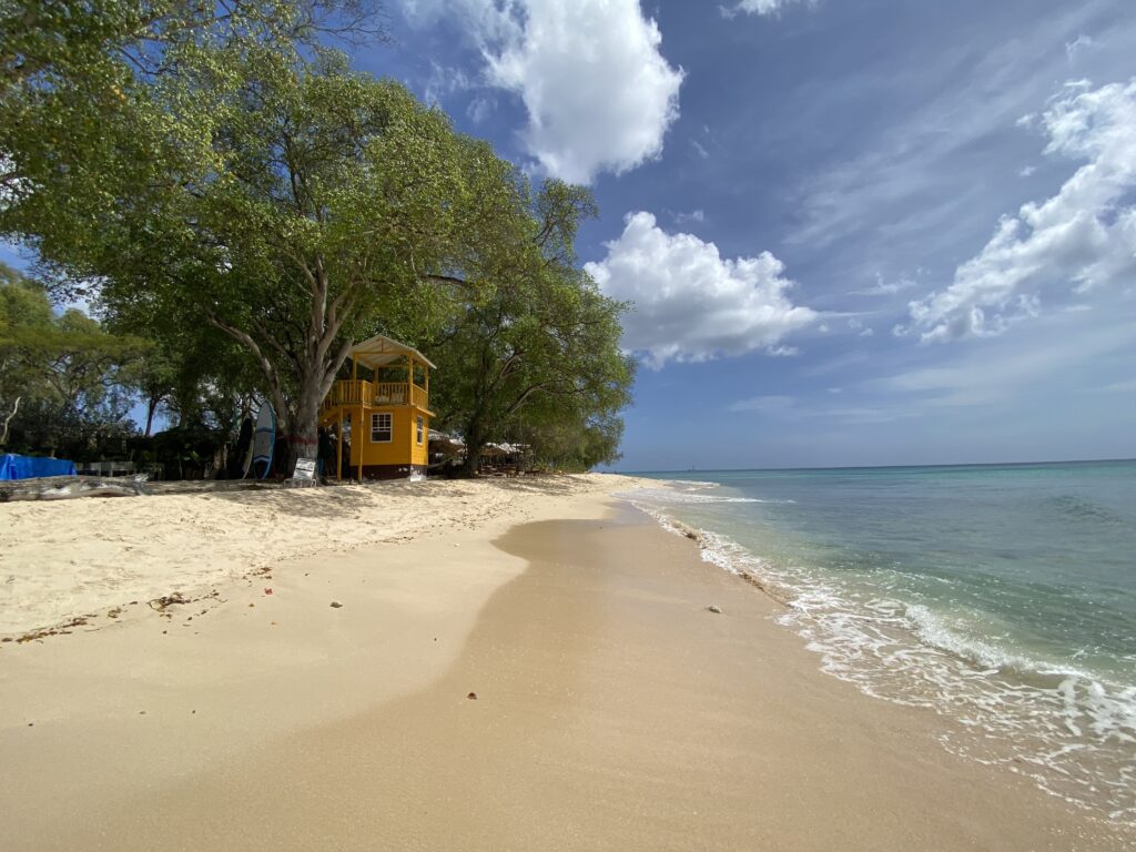 a yellow building on a beach