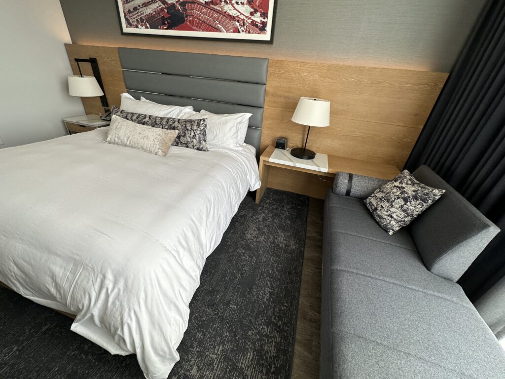 a bed with a couch and a lamp