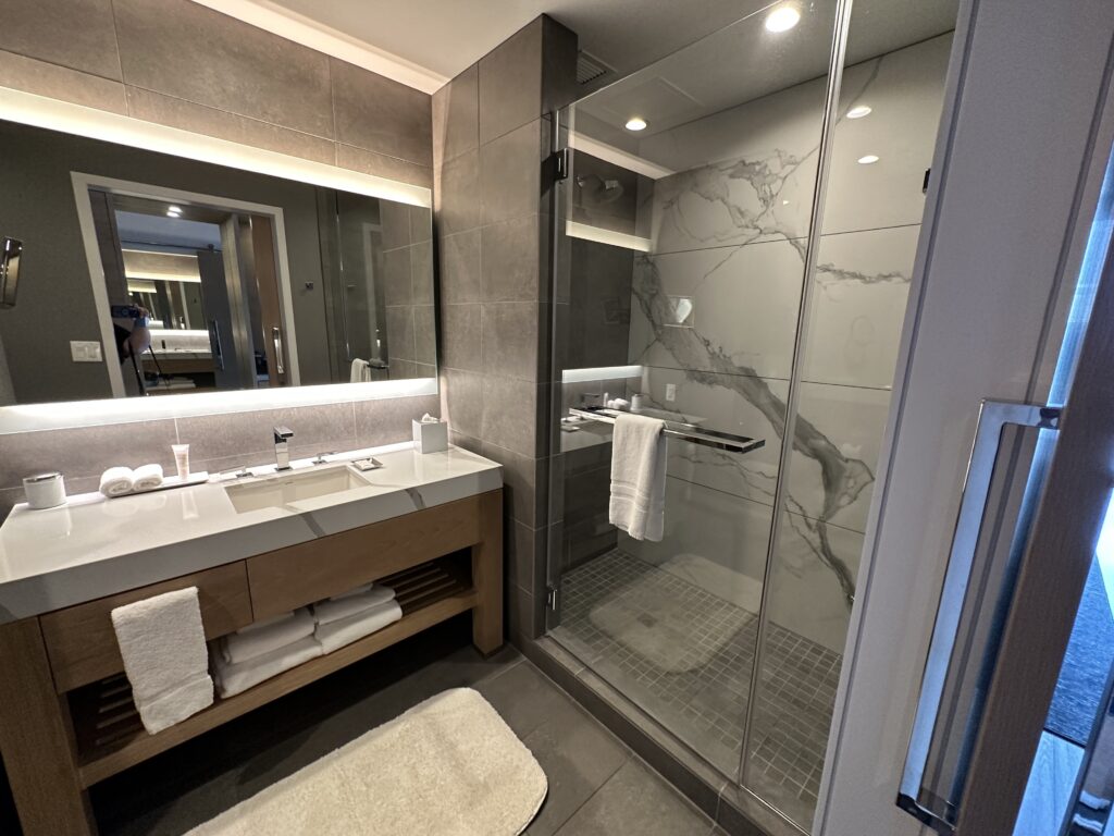 a bathroom with a glass shower and sink