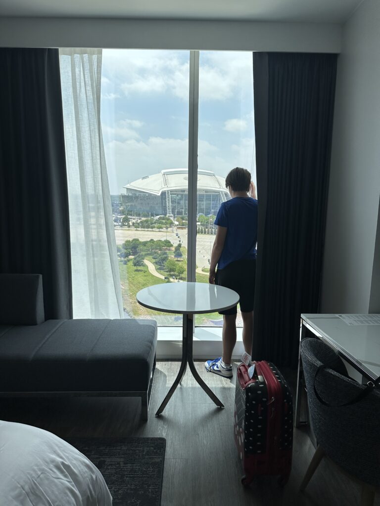 a person standing in front of a window looking out a building