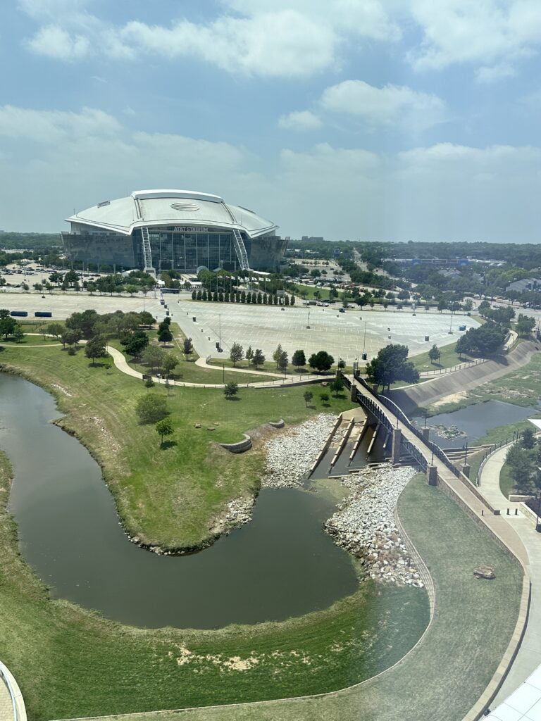 a stadium with a river and a bridge