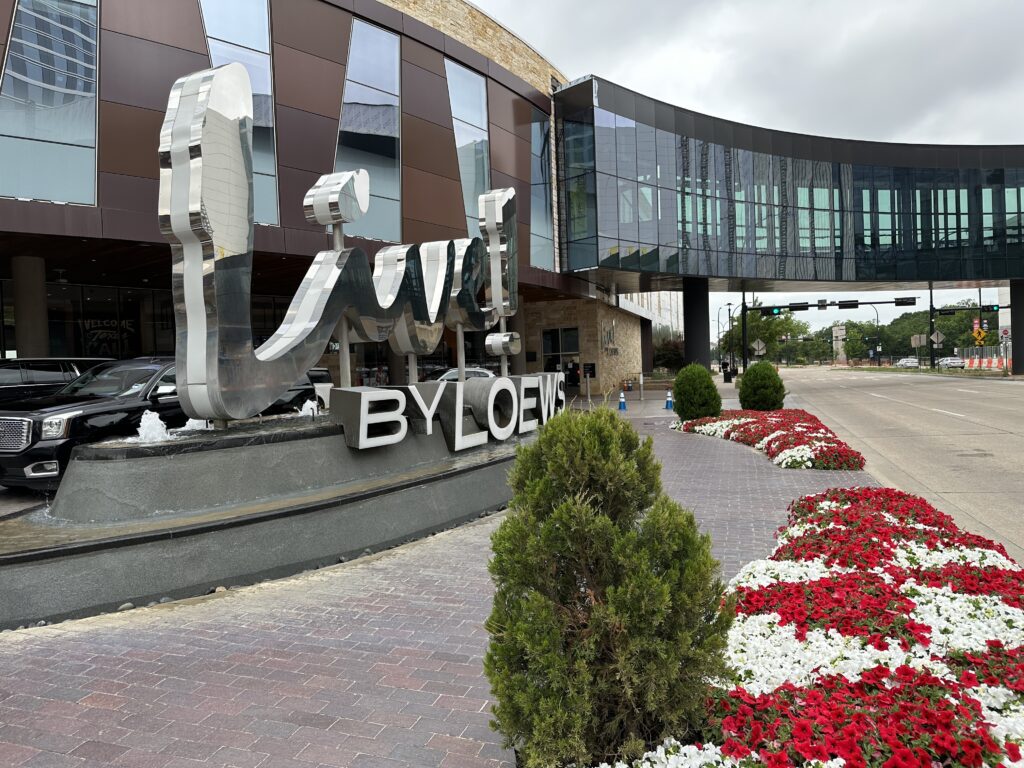 a building with a sign and flowers