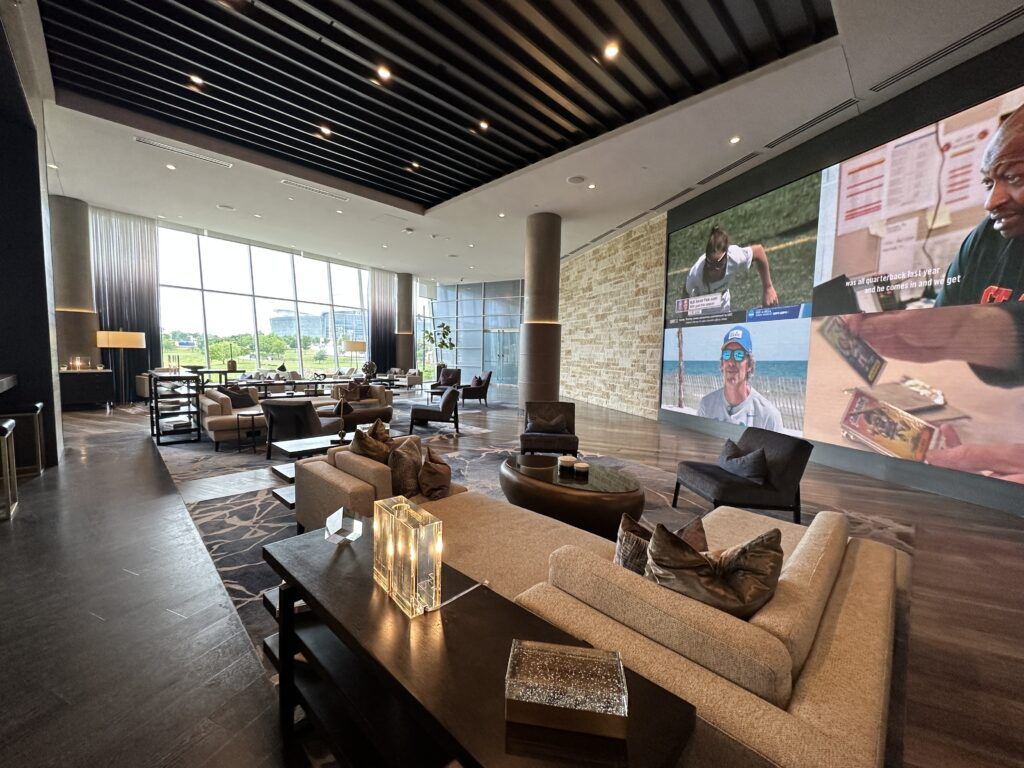 a large room with couches and a large screen