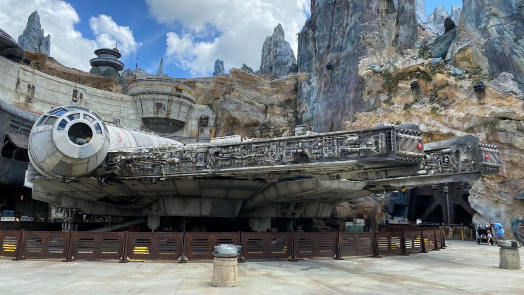 a space ship in front of a rocky mountain