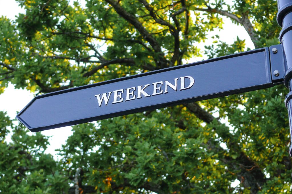 a street sign with trees in the background