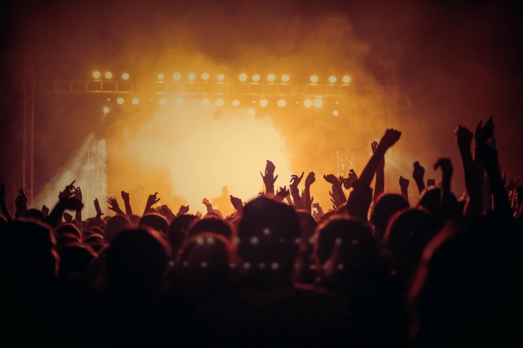 a crowd of people with their hands up in the air