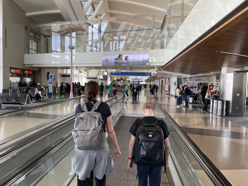 people walking on an escalator in a building