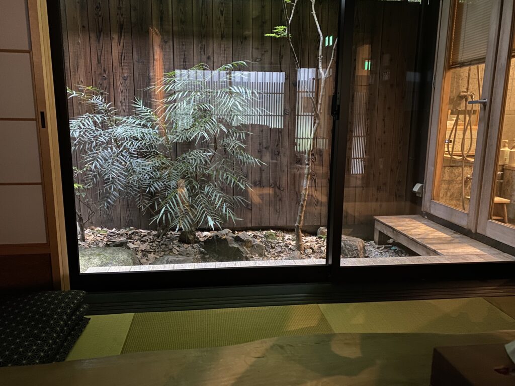 a room with a glass door and a tree