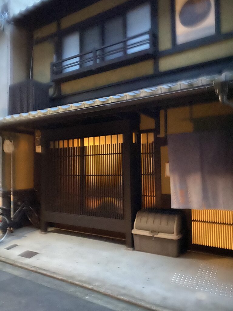 a building with a door and a trash can