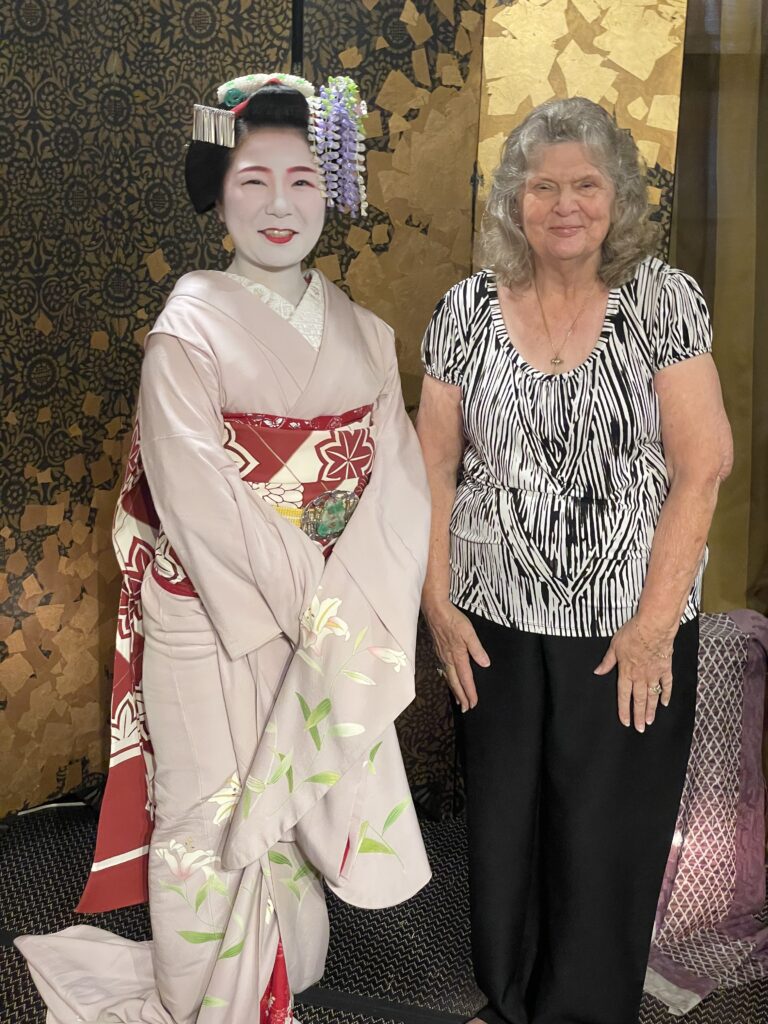 a woman standing next to a woman in a garment
