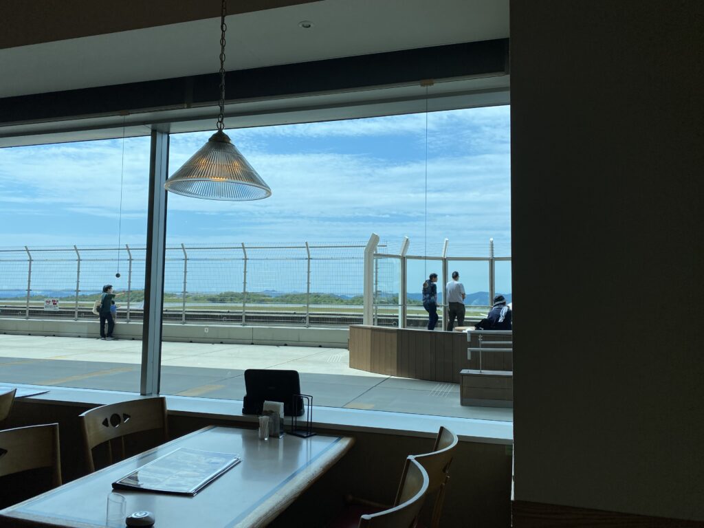 a room with a window and people walking