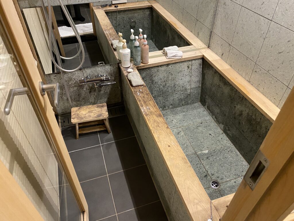 a bathtub with soaps and bottles on it