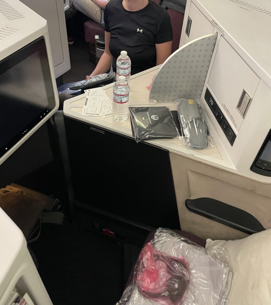 a person sitting at a desk in an airplane